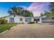 White house with blue accents, paved driveway, and carport at 5823 26Th W St, Bradenton, FL 34207