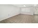 Living room with tile flooring and a window with blinds at 5823 26Th W St, Bradenton, FL 34207