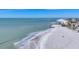 Aerial view of beach, ocean, and shoreline homes at 608 Bayview Dr, Longboat Key, FL 34228