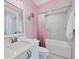 Stylish bathroom with pink walls and marble shower surround at 608 Bayview Dr, Longboat Key, FL 34228