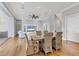 Bright dining area with rustic farmhouse table and wicker chairs at 608 Bayview Dr, Longboat Key, FL 34228