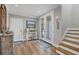 Bright and airy foyer with hardwood floors and staircase at 608 Bayview Dr, Longboat Key, FL 34228