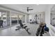 Well-equipped home gym with various exercise machines and weights at 608 Bayview Dr, Longboat Key, FL 34228