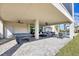 Expansive covered patio with ping pong table and lounge furniture at 608 Bayview Dr, Longboat Key, FL 34228