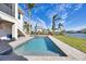 Stunning rectangular pool with spacious patio; serene waterfront setting at 608 Bayview Dr, Longboat Key, FL 34228