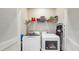 Convenient laundry room with washer, dryer, and overhead shelving at 6217 116Th E Ave, Parrish, FL 34219