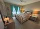 Bright bedroom with a queen-size bed and wicker furniture at 6504 Bowdoin Pl # 15, Bradenton, FL 34207