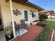 Brick paved porch with seating and attractive metal art at 6504 Bowdoin Pl # 15, Bradenton, FL 34207