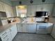 Updated kitchen featuring white cabinets and new appliances at 6504 Bowdoin Pl # 15, Bradenton, FL 34207