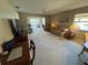 Spacious living area with seating and a view to the kitchen at 6504 Bowdoin Pl # 15, Bradenton, FL 34207