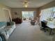 Living room with access to Florida room and view of backyard at 6504 Bowdoin Pl # 15, Bradenton, FL 34207