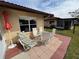 Relaxing patio with seating area and red brick pavers at 6504 Bowdoin Pl # 15, Bradenton, FL 34207