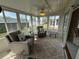 Bright sunroom with comfy seating and view of backyard at 6504 Bowdoin Pl # 15, Bradenton, FL 34207