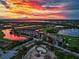 Sunset aerial view of the community, highlighting the golf course and surrounding lakes at 7005 River Hammock Dr # 301, Bradenton, FL 34212