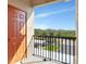 Inviting balcony view showcasing the parking area surrounded by lush greenery and bright blue skies at 7005 River Hammock Dr # 301, Bradenton, FL 34212