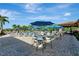 Outdoor poolside patio featuring tables, seating, and umbrellas for relaxation and shade at 7005 River Hammock Dr # 301, Bradenton, FL 34212