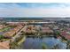 Aerial view of the community highlighting its layout, lake and surrounding landscape at 7325 Skybird Rd, Bradenton, FL 34209