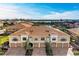 Aerial view of townhouses with lake and lush landscaping at 7325 Skybird Rd, Bradenton, FL 34209