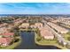 Aerial perspective of community with lake, showcasing various homes and landscaping at 7325 Skybird Rd, Bradenton, FL 34209