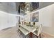 Bright dining room features a glass-top table and modern chandelier at 7325 Skybird Rd, Bradenton, FL 34209