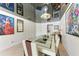 Elegant dining room with a glass-top table and modern chandelier at 7325 Skybird Rd, Bradenton, FL 34209