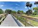 Wooden footbridge walkway over a grassy area with palm trees at 7325 Skybird Rd, Bradenton, FL 34209