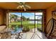 Screened porch with table and chairs overlooking pond at 7325 Skybird Rd, Bradenton, FL 34209