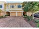 Front view of townhouse with attached garage and landscaping at 7325 Skybird Rd, Bradenton, FL 34209