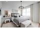 Bright bedroom with gray bedding and modern chandelier at 7398 Marathon Dr, Seminole, FL 33777