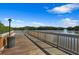 Wooden fishing deck with bench overlooking the water at 7398 Marathon Dr, Seminole, FL 33777