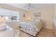 Bright bedroom with floral bedding and wood floors at 755 Village Cir # 203, Venice, FL 34292