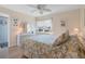 Bedroom with a floral comforter and ceiling fan at 755 Village Cir # 203, Venice, FL 34292