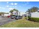 Exterior view of a condo building with parking lot and landscaping at 755 Village Cir # 203, Venice, FL 34292