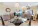 Condo dining area with glass top table and four chairs at 755 Village Cir # 203, Venice, FL 34292