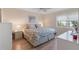 Main bedroom with king-size bed, window seating and light wood furniture at 755 Village Cir # 203, Venice, FL 34292