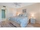 King-size bed and light wood furniture in this main bedroom with a view at 755 Village Cir # 203, Venice, FL 34292