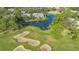 Scenic aerial shot of a golf course home nestled on a pond, offering peaceful waterfront living at 7703 Whitebridge Gln, University Park, FL 34201