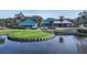 Aerial view of community buildings, showcasing the beautiful landscaping and serene lake views at 7703 Whitebridge Gln, University Park, FL 34201