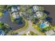 Beautiful aerial view of a home located on a pond near a community pool and golf course at 7703 Whitebridge Gln, University Park, FL 34201