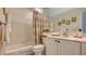 Well-lit bathroom with a shower-tub combo and a vanity with ample storage at 7703 Whitebridge Gln, University Park, FL 34201