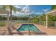 Intimate community spa with scenic pond views, surrounded by lush landscaping and tranquil setting at 7703 Whitebridge Gln, University Park, FL 34201