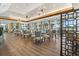 Elegant dining room featuring hardwood floors, stylish chandeliers, and abundant natural light at 7703 Whitebridge Gln, University Park, FL 34201