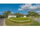 Welcoming entrance to University Park with manicured landscaping and vibrant flower beds at 7703 Whitebridge Gln, University Park, FL 34201