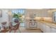 Well-lit kitchen featuring white appliances, granite countertops, and a view of the patio at 7703 Whitebridge Gln, University Park, FL 34201