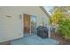 Exterior view of a patio with outdoor grill, with a view into the kitchen and dining area at 7703 Whitebridge Gln, University Park, FL 34201