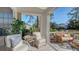 Relaxing sunroom showcasing comfortable wicker furniture and tranquil outdoor views with tropical landscaping at 7703 Whitebridge Gln, University Park, FL 34201