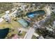 Aerial view of community with tennis courts, lake, and homes at 8009 55Th E St, Palmetto, FL 34221