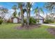 Brick home with lush landscaping and palm trees at 8009 55Th E St, Palmetto, FL 34221