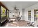 Screened porch with tile floor, ceiling fan, and French doors at 8009 55Th E St, Palmetto, FL 34221