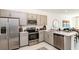 Modern kitchen with gray cabinets, stainless steel appliances, and quartz countertops at 8572 Daybreak St, Sarasota, FL 34241